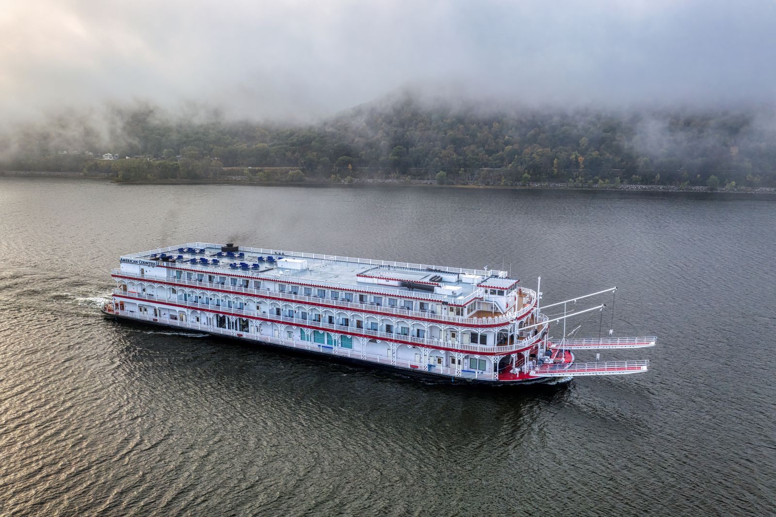 Paddlewheel riverboat in morning mist